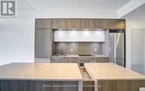 Toronto (Regent Park) condo for rent - A modern kitchen with a wooden countertop and a sink.