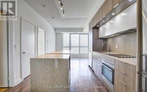Toronto (Regent Park) condo for rent - A modern kitchen with wooden cabinets and stainless steel appliances.