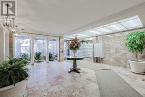 Toronto (The Beaches) multi-family for rent - A real estate brokerage office with a large marble floor and a chandelier.