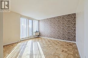 Toronto (The Beaches) multi-family for rent - A room with a brick wall and a tiled floor.