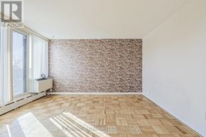 Toronto (The Beaches) multi-family for rent - A room with a brick wall and wooden flooring.