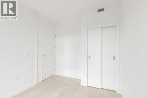 Burnaby apartment for rent - A white room with a door on the left and a white door on the right.