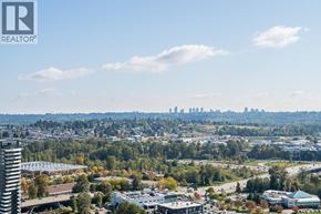 Burnaby apartment for rent - A cityscape with a clear sky and a tall building in the foreground.