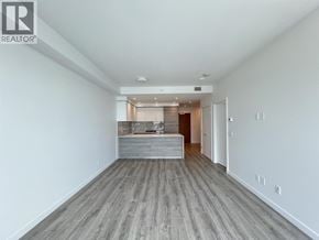 New Westminster apartment for rent - A spacious room with a wooden floor and white walls.