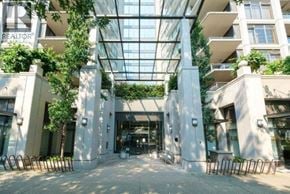 Richmond apartment for rent - A glass ceiling with plants hanging from it and a building with a sign that says REALTOR.