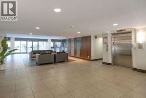 Richmond apartment for rent - A spacious lobby area with a reception desk and a potted plant.