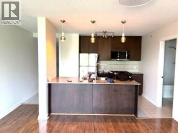 Richmond apartment for rent - A kitchen with a wooden island and a microwave above it.
