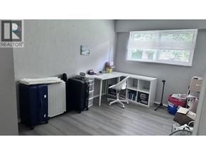 North Vancouver apartment for rent - A room with a white desk, a radiator, and a window with blinds.
