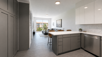 Los Angeles apartment for rent - A modern kitchen with a dining table and chairs in the middle of the room.