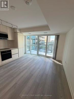 Toronto (Mount Pleasant West) condo for rent - A spacious kitchen with wooden flooring and a large window.