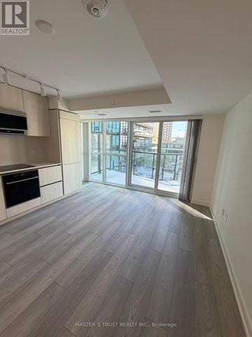 Toronto (Mount Pleasant West) condo for rent - A spacious kitchen with wooden flooring and a large window.