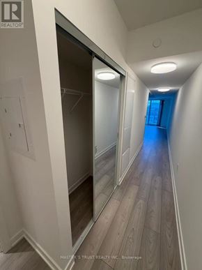Toronto (Mount Pleasant West) condo for rent - A hallway with wood floors and white walls.