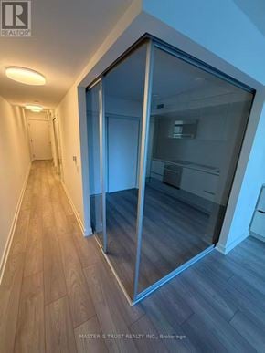 Toronto (Mount Pleasant West) condo for rent - A hallway with a glass door leading to a room.