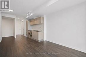 Toronto (Church-Yonge Corridor) condo for rent - A spacious kitchen with wooden floors and white walls.