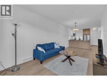 Coquitlam apartment for rent - A blue sofa sits in a living room with a television and a coffee table.