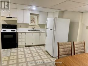 Whitchurch-Stouffville apartment for rent - A kitchen with white cabinets and a white fridge.