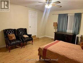 Whitchurch-Stouffville apartment for rent - A bedroom with a bed, two chairs, and a dresser.