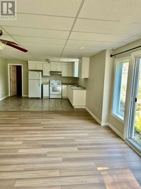 Whitchurch-Stouffville apartment for rent - A kitchen with white appliances and wooden floors.