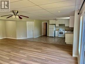 Whitchurch-Stouffville apartment for rent - A kitchen with white cabinets and a ceiling fan.
