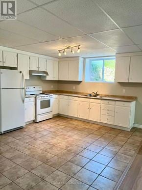 Whitchurch-Stouffville apartment for rent - A kitchen with white appliances and cabinets.