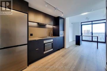 Hamilton (Beasley) condo for rent - A modern kitchen with dark wood cabinets and stainless steel appliances.