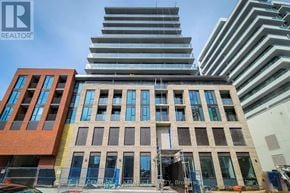 Hamilton (Beasley) condo for rent - A tall building with many windows is under construction.