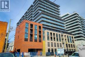 Hamilton (Beasley) condo for rent - A tall building with a sign that says "REALTOR" on it.