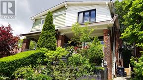 Toronto (Woodbine Corridor) apartment for rent - A house with a well-maintained garden in front.