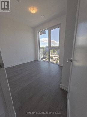 Hamilton (Corktown) condo for rent - A room with a view of the city through a large window.