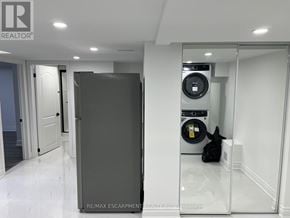 Hamilton (Stoney Creek Mountain) apartment for rent - A modern laundry room with a washer and dryer built into the wall.