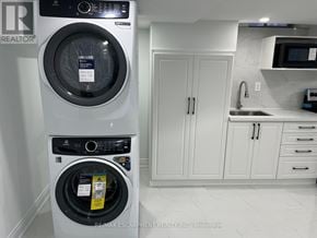 Hamilton (Stoney Creek Mountain) apartment for rent - A white front loading washing machine with a black control panel and a white dryer with a black control panel.