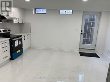 Hamilton (Stoney Creek Mountain) apartment for rent - A kitchen with white cabinets and a black dishwasher.
