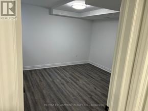 Hamilton (Stoney Creek Mountain) apartment for rent - A room with wooden flooring and white walls.