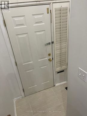 Toronto (Morningside) townhouse for rent - A white door with a gold handle and a white wall with a switchboard.