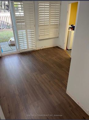 Toronto (Morningside) townhouse for rent - A room with wooden flooring and white walls.