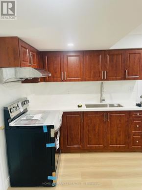 Oakville (Wm Westmount) apartment for rent - A kitchen with wooden cabinets and a black dishwasher.