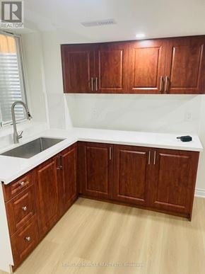 Oakville (Wm Westmount) apartment for rent - A kitchen with wooden cabinets and a white counter.