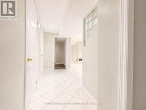 Mississauga (East Credit) apartment for rent - A hallway with white walls and a tiled floor.