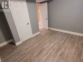 Mississauga (Hurontario) apartment for rent - A room with a wooden floor and two white doors.
