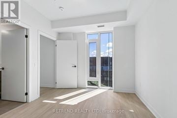 Toronto (Banbury-Don Mills) condo for rent - A white kitchen with a black counter top and wooden floors.