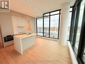 Toronto (Don Valley Village) condo for rent - A kitchen with a white island and wooden floors.