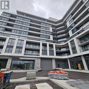 Toronto (Clairlea-Birchmount) condo for rent - A large, modern building with many windows and balconies is under construction.