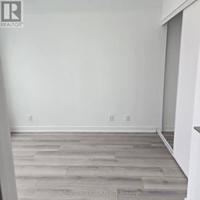 Toronto (Clairlea-Birchmount) condo for rent - A room with wooden flooring and white walls.