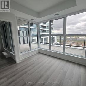 Toronto (Clairlea-Birchmount) condo for rent - A room with a view of a construction site through large windows.