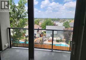 Windsor condo for rent - A balcony with a view of a residential area.