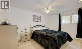 Kitchener apartment for rent - A bedroom with a bed, nightstand, and a dresser.