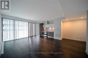 Toronto (Church-Yonge Corridor) condo for rent - A spacious room with wooden floors and a large window with blinds.