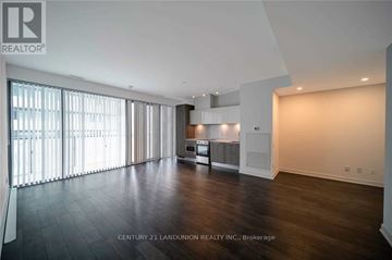 Toronto (Church-Yonge Corridor) condo for rent - A spacious room with wooden floors and a large window with blinds.