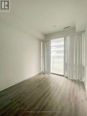 Toronto (Church-Yonge Corridor) condo for rent - A room with wooden flooring and a sliding glass door.