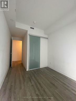 Toronto (Church-Yonge Corridor) condo for rent - A room with a glass door and wooden flooring.